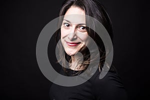 Young caucasian woman portrait on black background