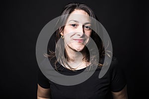 Young caucasian woman portrait on black background