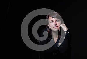 Young caucasian woman portrait on black background in studio