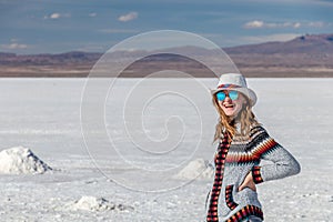 Young caucasian woman portrait. Female traveling girl happy and smiling in white salt flat Uyuni, Bolivia