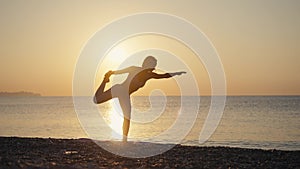 Young caucasian woman practicing yoga. Woman silhouette making yoga