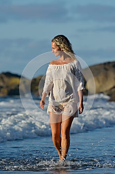 Young caucasian woman refreshing on the beach