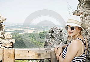 Young caucasian woman in a sailor outfit is posing on the ruins