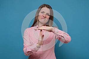 Young caucasian woman showing a timeout gesture