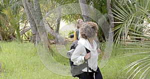 Young Caucasian woman smiles in the background with copy space as a young biracial woman walks ahead