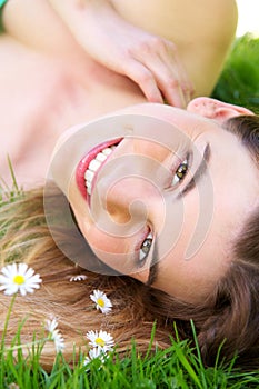 Young caucasian woman smiling outdoors with flowers