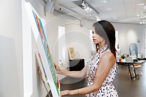 Young caucasian woman standing in art gallery