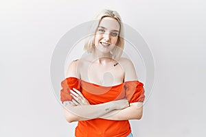 Young caucasian woman standing over isolated background happy face smiling with crossed arms looking at the camera