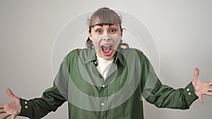 Young caucasian woman standing with surprise expression and raised arms over isolated white background