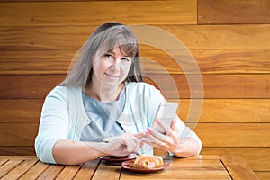 Young Caucasian woman with straight hair drinking tea in a coffee shop