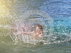 Young caucasian woman swimming in lake