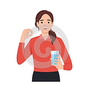 Young caucasian woman taking pills. Healthy woman holding pills and glass of water in hands. Happy smiling woman taking pills.