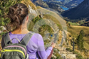 Young caucasian woman in the top of the mountain doing yoga and meditation in the Swiss Alps. Travel and sport concept