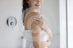 Young Caucasian woman touch healthy soft body after shower