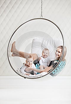 Young Caucasian woman with two babies having fun