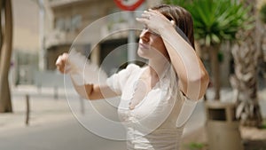 Young caucasian woman using handfan sweating at street