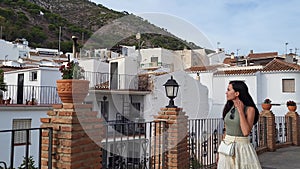 Young caucasian woman visiting typical spanish andalusian town. Slow motioned