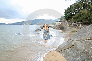 Young caucasian woman walking barefoot on sand, morning sea shore.