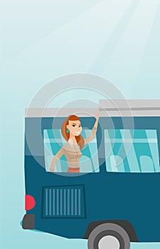Young caucasian woman waving hand from bus window.