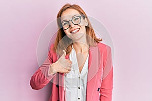 Young caucasian woman wearing business style and glasses doing happy thumbs up gesture with hand