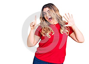 Young caucasian woman wearing casual clothes showing and pointing up with fingers number seven while smiling confident and happy