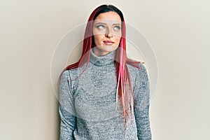 Young caucasian woman wearing casual clothes smiling looking to the side and staring away thinking