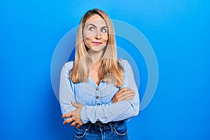 Young caucasian woman wearing casual clothes smiling looking to the side and staring away thinking