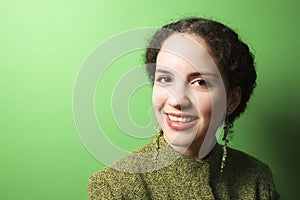 Young Caucasian woman wearing green clothing.