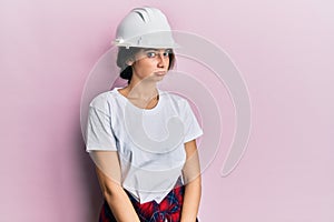 Young caucasian woman wearing hardhat depressed and worry for distress, crying angry and afraid