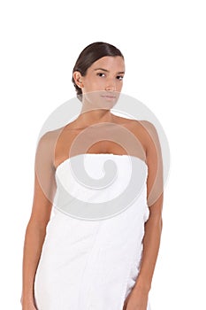 Young Caucasian woman wrapped in bath towel