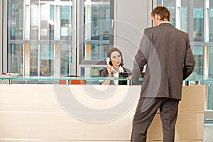 Young caucassian secretary assisting businessman