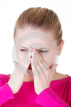 Young caucassian woman is having sinus pressure.