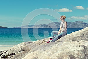 Young Caucassian woman on a white sandy beach in Luskentyre, Isle of Harris, Scotland