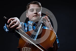 Young Cellist playing classical music on cello