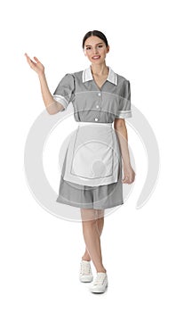 Young chambermaid in uniform on background
