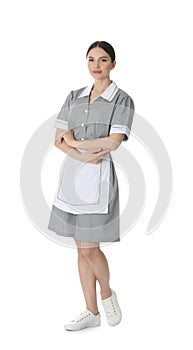 Young chambermaid in uniform on background