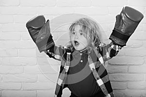 Young champion. champion or happy small boy in red boxing gloves, winning