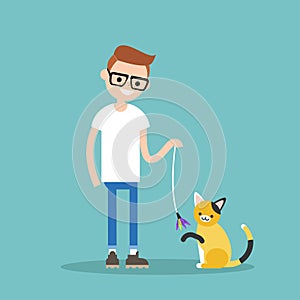 Young character playing with a cat / flat editable vector illustration, clip art