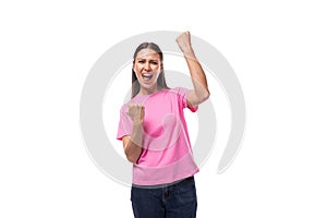 young charismatic good-looking woman with black hair wearing a pink t-shirt is experiencing joy and pleasure