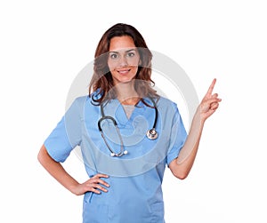 Young charismatic nurse standing and pointing