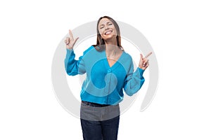 young charming brunette lady dressed in a blue V-neck sweater actively jests on a white background with copy space