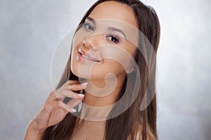 Young charming brunette smiling. Beauty portrait of a young beautiful woman.