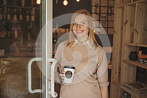 Young charming woman calling with cell telephone while sitting alone in coffee shop during free time, attractive female