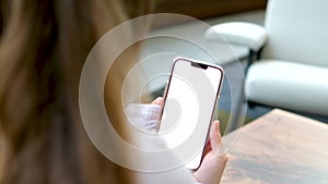 Young charming woman calling with cell telephone while sitting alone in coffee shop during free time, attractive female