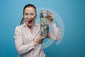 Young charming woman holds a jar