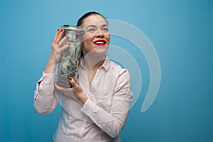 Young charming woman holds a jar