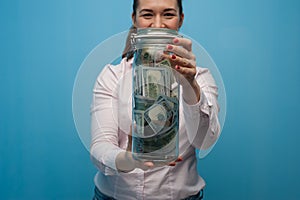 Young charming woman holds a jar