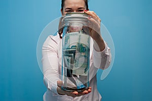 Young charming woman holds a jar