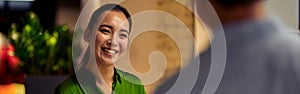 Young cheerful asian woman, female office worker giving some documents to her colleague and smiling while standing