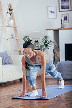 Young cheerful attractive woman practicing yoga